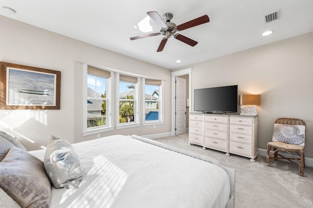 bedroom with light colored carpet and ceiling fan