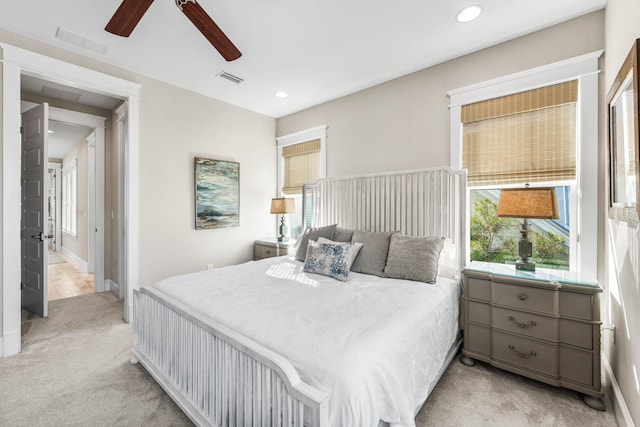 bedroom with light carpet and ceiling fan