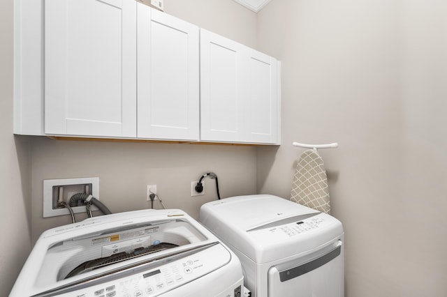 laundry area with washer and dryer and cabinets