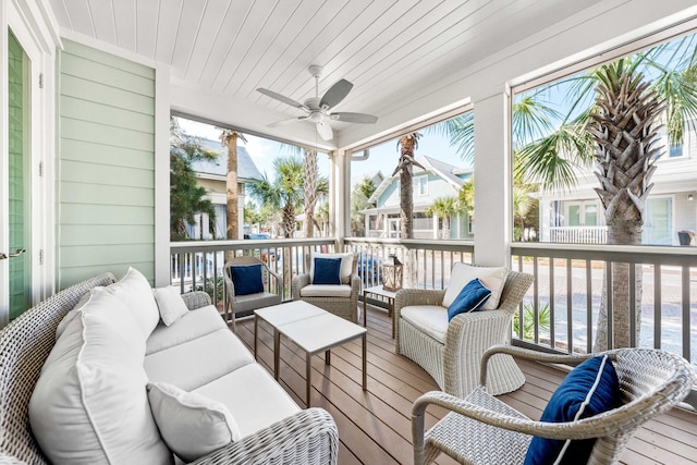 sunroom with ceiling fan and wooden ceiling