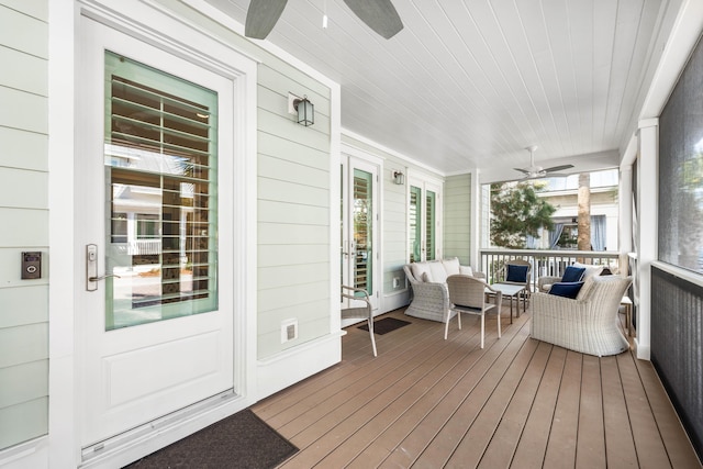 sunroom / solarium with plenty of natural light, wooden ceiling, and ceiling fan