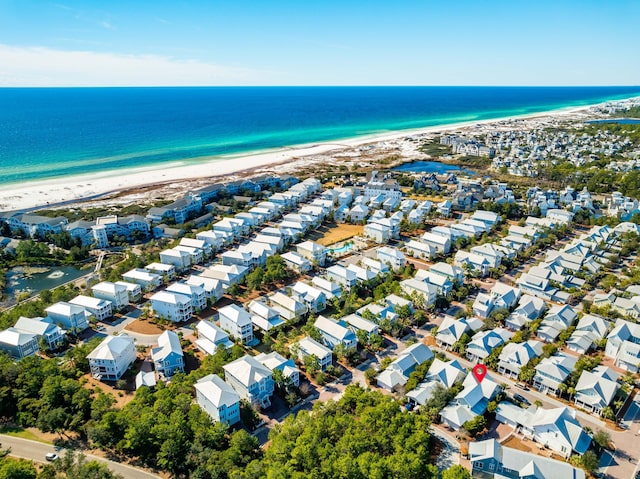 drone / aerial view featuring a water view and a beach view