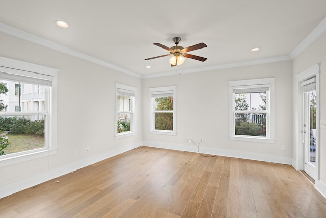 spare room featuring light wood-type flooring, crown molding, baseboards, and recessed lighting