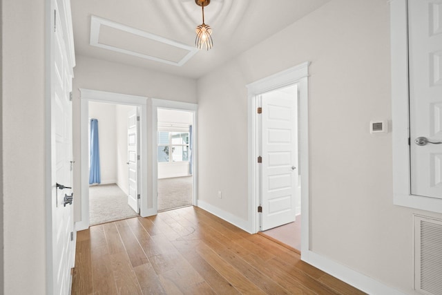 interior space featuring hardwood / wood-style floors, visible vents, and baseboards