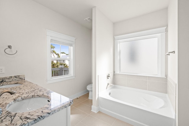 bathroom featuring toilet, a garden tub, a sink, and tile patterned floors