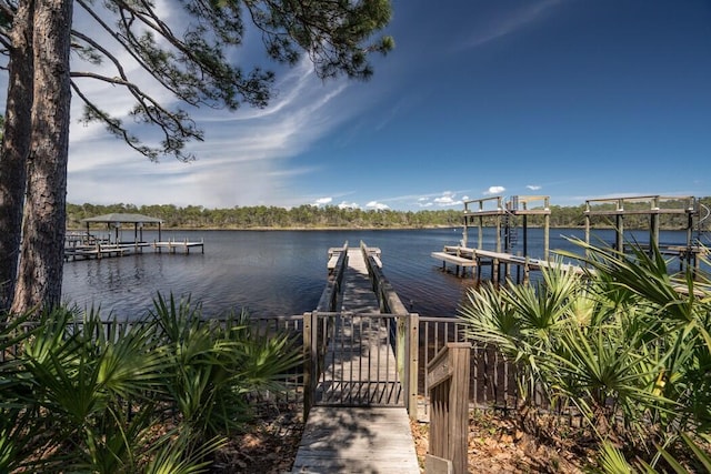 dock area with a water view and boat lift