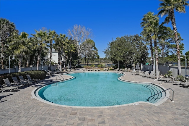 pool featuring fence and a patio