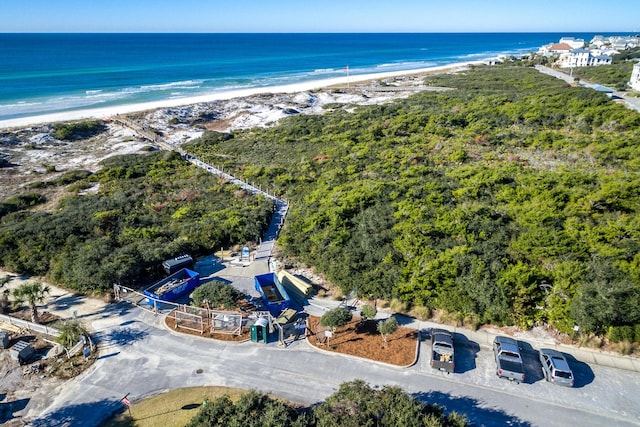 aerial view with a water view and a beach view