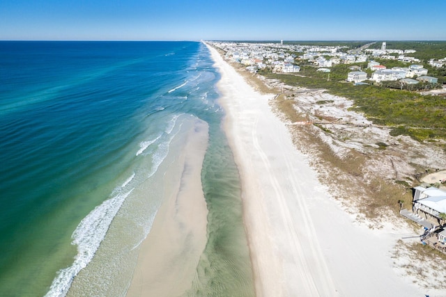 bird's eye view with a water view and a beach view