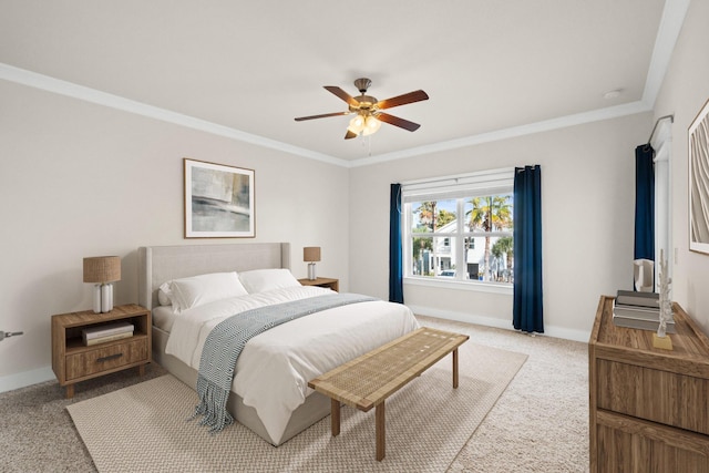 carpeted bedroom with ornamental molding, ceiling fan, and baseboards