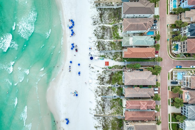 aerial view with a water view and a beach view