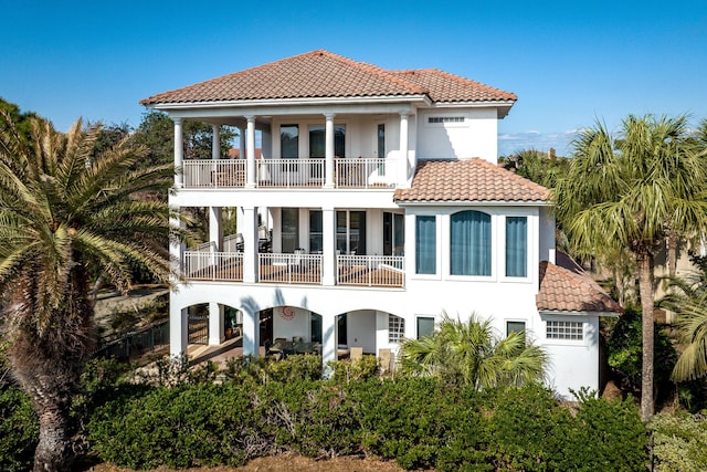 rear view of property featuring a balcony