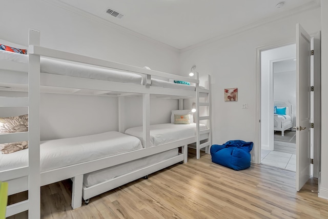 bedroom with hardwood / wood-style flooring and ornamental molding