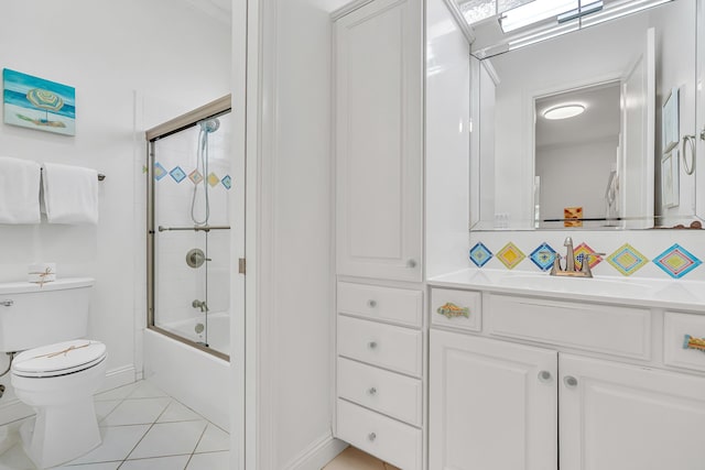 full bathroom featuring toilet, vanity, shower / bath combination with glass door, and tile patterned flooring