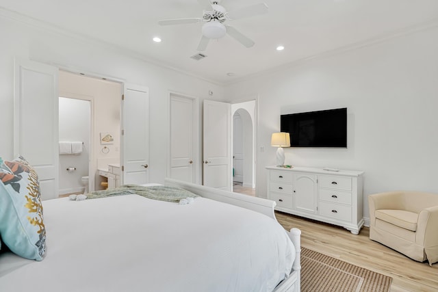 bedroom featuring crown molding, light hardwood / wood-style flooring, ensuite bath, and ceiling fan