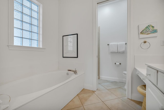 bathroom with tile patterned flooring, a tub to relax in, and toilet