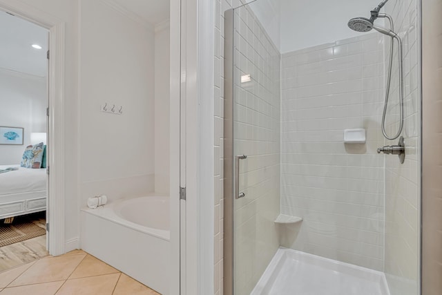 bathroom featuring tile patterned floors, ornamental molding, and separate shower and tub