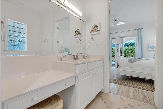 bathroom featuring ornamental molding, tile patterned floors, ceiling fan, and vanity