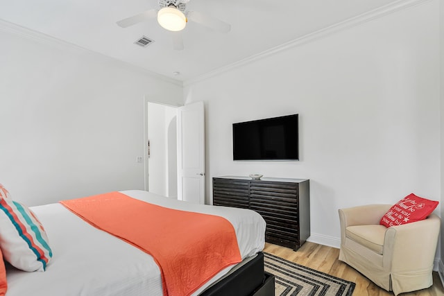 bedroom featuring ornamental molding, ceiling fan, and light hardwood / wood-style floors