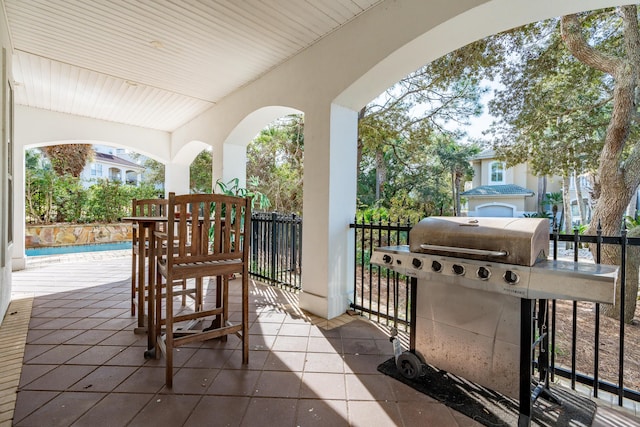 view of patio with a grill and a fenced in pool