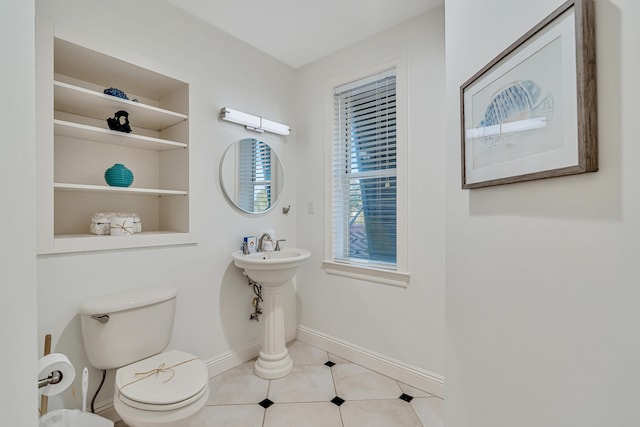 bathroom featuring built in features, tile patterned floors, and toilet