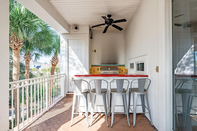 balcony featuring a grill, ceiling fan, and exterior bar