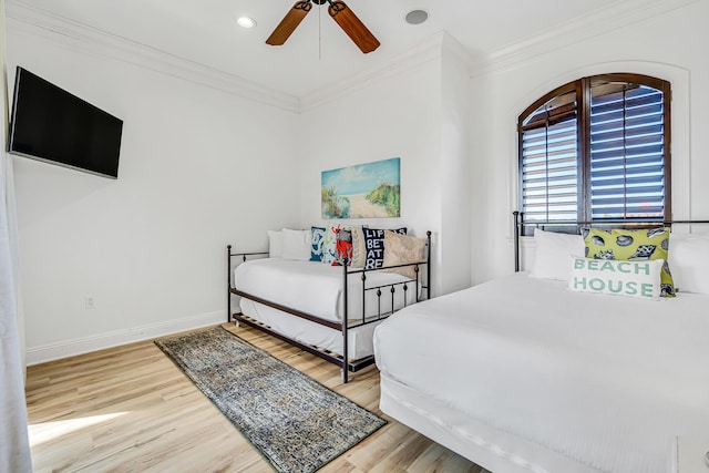 bedroom featuring crown molding, ceiling fan, and hardwood / wood-style flooring