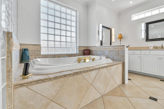 bathroom featuring ornamental molding, tile patterned flooring, vanity, and tiled tub