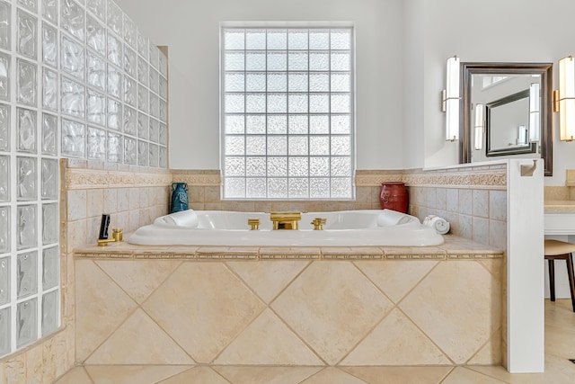 bathroom featuring tiled bath and tile patterned flooring