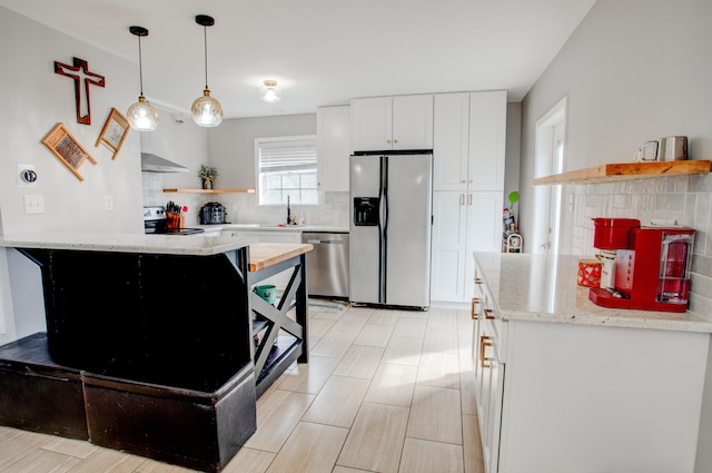 kitchen featuring backsplash, white cabinets, appliances with stainless steel finishes, and open shelves