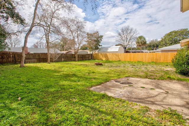 view of yard featuring a patio and a fenced backyard