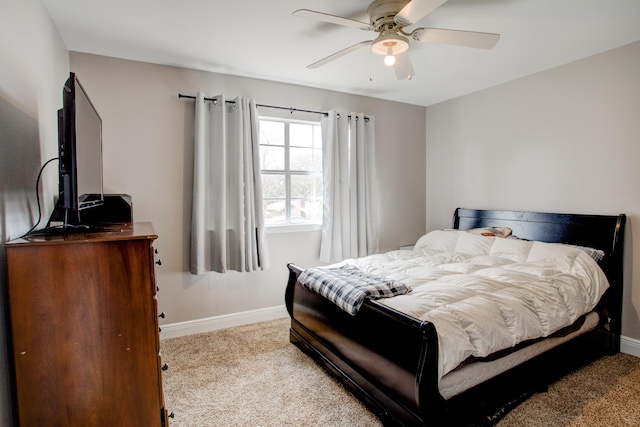 carpeted bedroom featuring a ceiling fan and baseboards