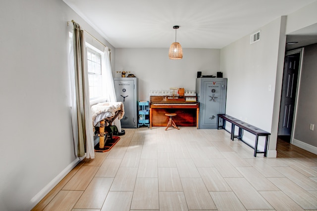 interior space with visible vents, baseboards, and wood finished floors