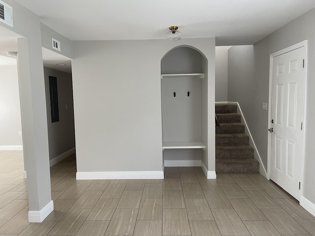 interior space with stairway, baseboards, and visible vents