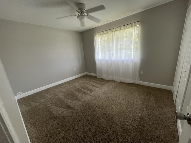 unfurnished bedroom with baseboards, carpet floors, and a ceiling fan