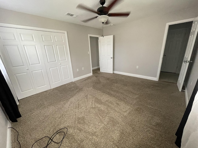 unfurnished bedroom with visible vents, baseboards, carpet, and a closet