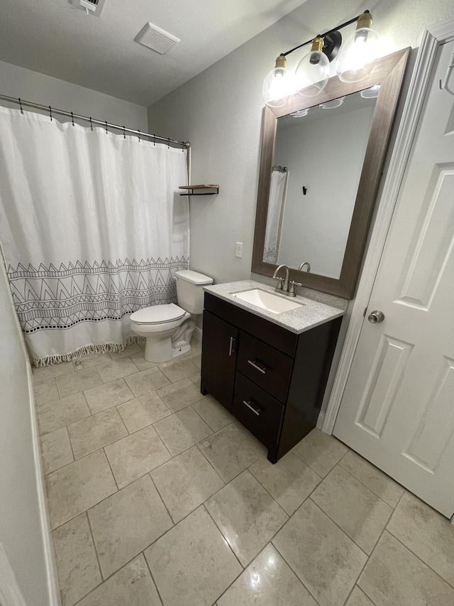 bathroom with tile patterned floors, toilet, and vanity