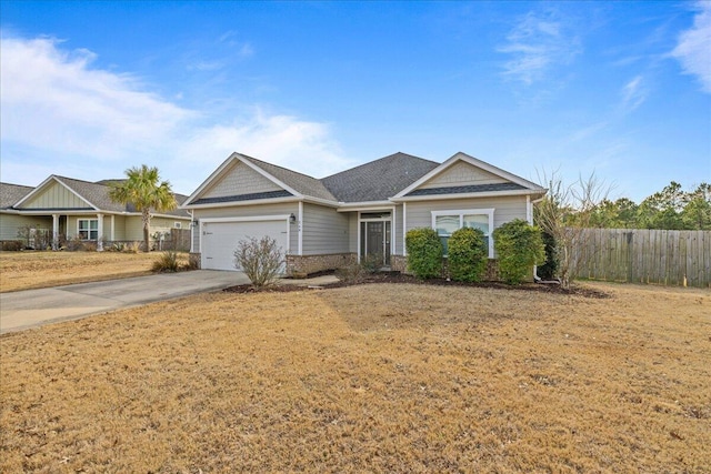 single story home featuring a garage, brick siding, fence, and driveway