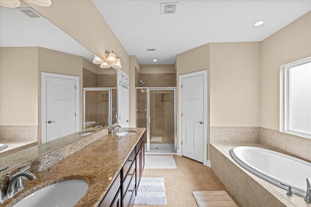 full bath featuring a garden tub, a sink, visible vents, and a shower stall