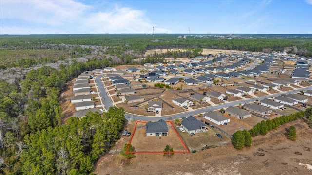 birds eye view of property featuring a residential view and a forest view