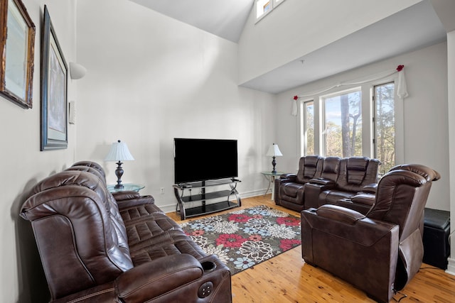 living room featuring hardwood / wood-style flooring and high vaulted ceiling
