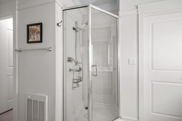bathroom featuring heating unit and walk in shower