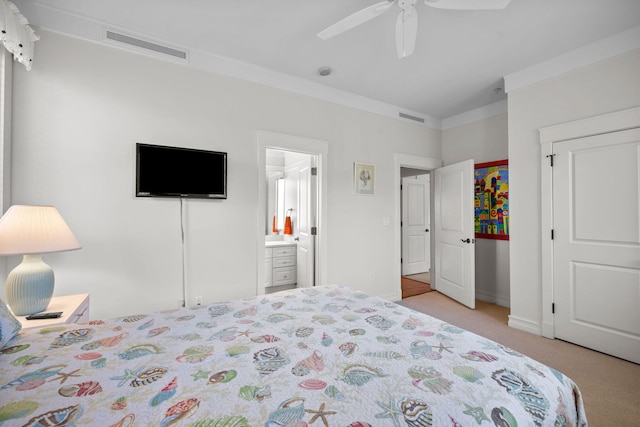 carpeted bedroom featuring ceiling fan, ornamental molding, and connected bathroom