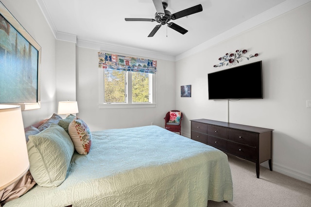carpeted bedroom featuring crown molding and ceiling fan