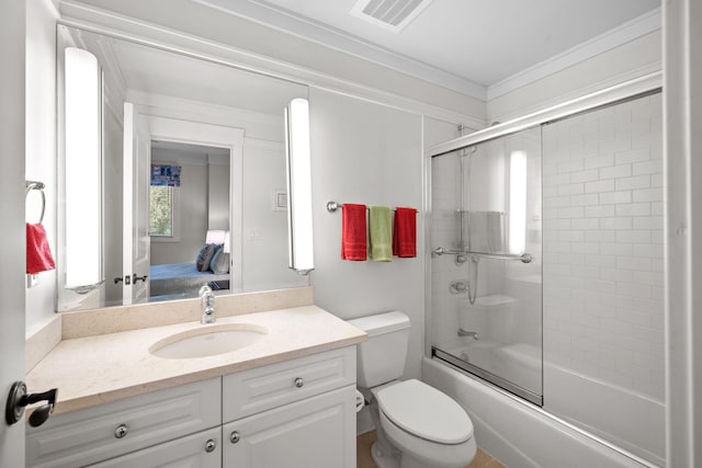 full bathroom with vanity, crown molding, shower / bath combination with glass door, and toilet