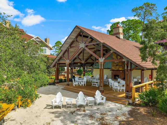 exterior space with a gazebo and a stone fireplace