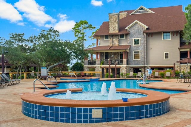 view of swimming pool featuring pool water feature