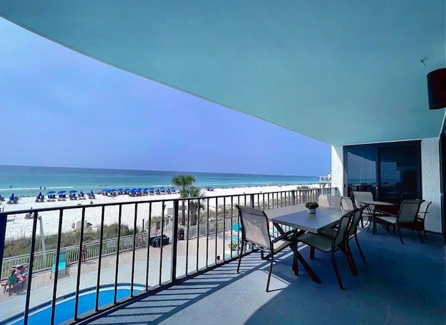 balcony featuring a water view and a beach view