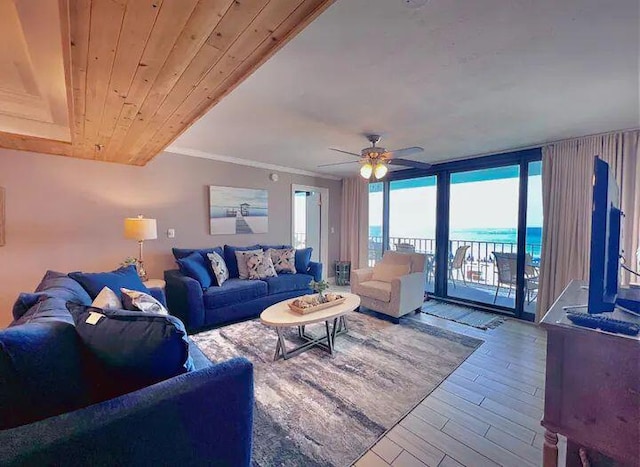 living room featuring wood-type flooring, a wall of windows, ceiling fan, crown molding, and wooden ceiling