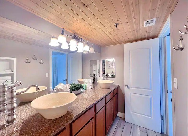 bathroom with vanity, hardwood / wood-style floors, and wooden ceiling